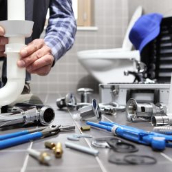 plumber at work in a bathroom, plumbing repair service, assemble and install concept