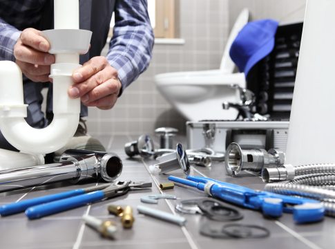 plumber at work in a bathroom, plumbing repair service, assemble and install concept