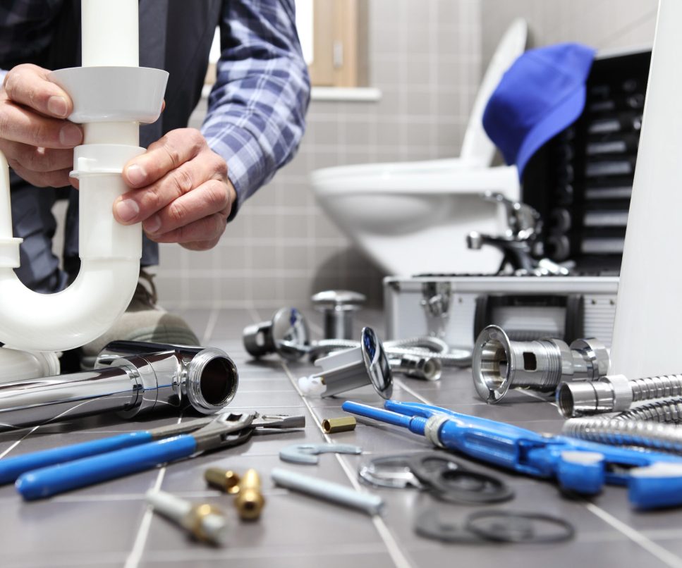 plumber at work in a bathroom, plumbing repair service, assemble and install concept