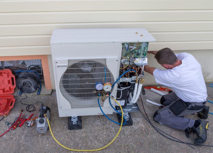 heat Pump. plumber at work installing a circulation pump