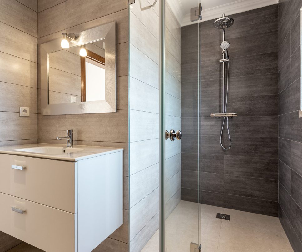 Modern bathroom with shower and washbasin for hygiene.
