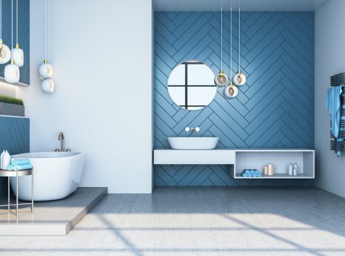 Modern blue bathroom interior with bath and decorative objects