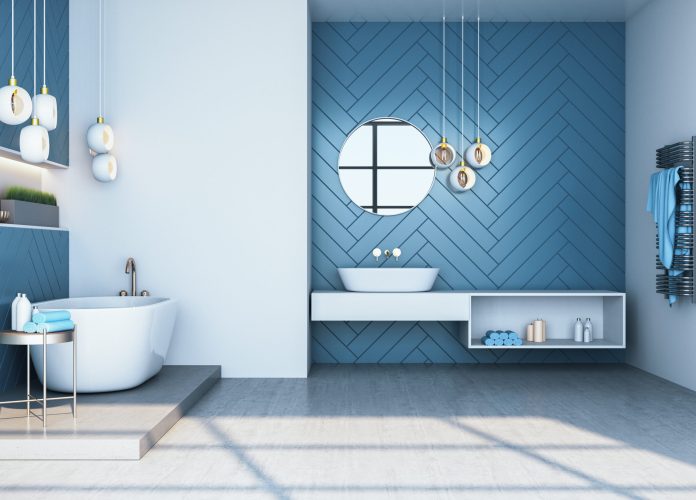 Modern blue bathroom interior with bath and decorative objects