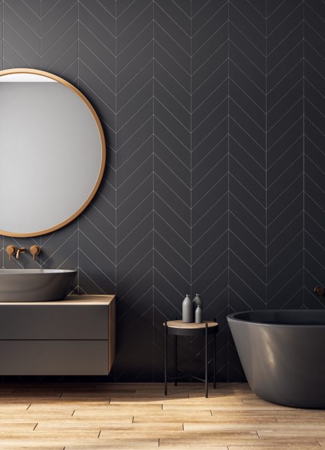 Modern black bathroom interior with decorative tree, bath tub, sink, round mirror, sunlight and copy space. 3D Rendering