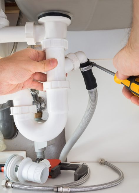 Close-up Of A Male Plumber Repairing Sink In Bathroom